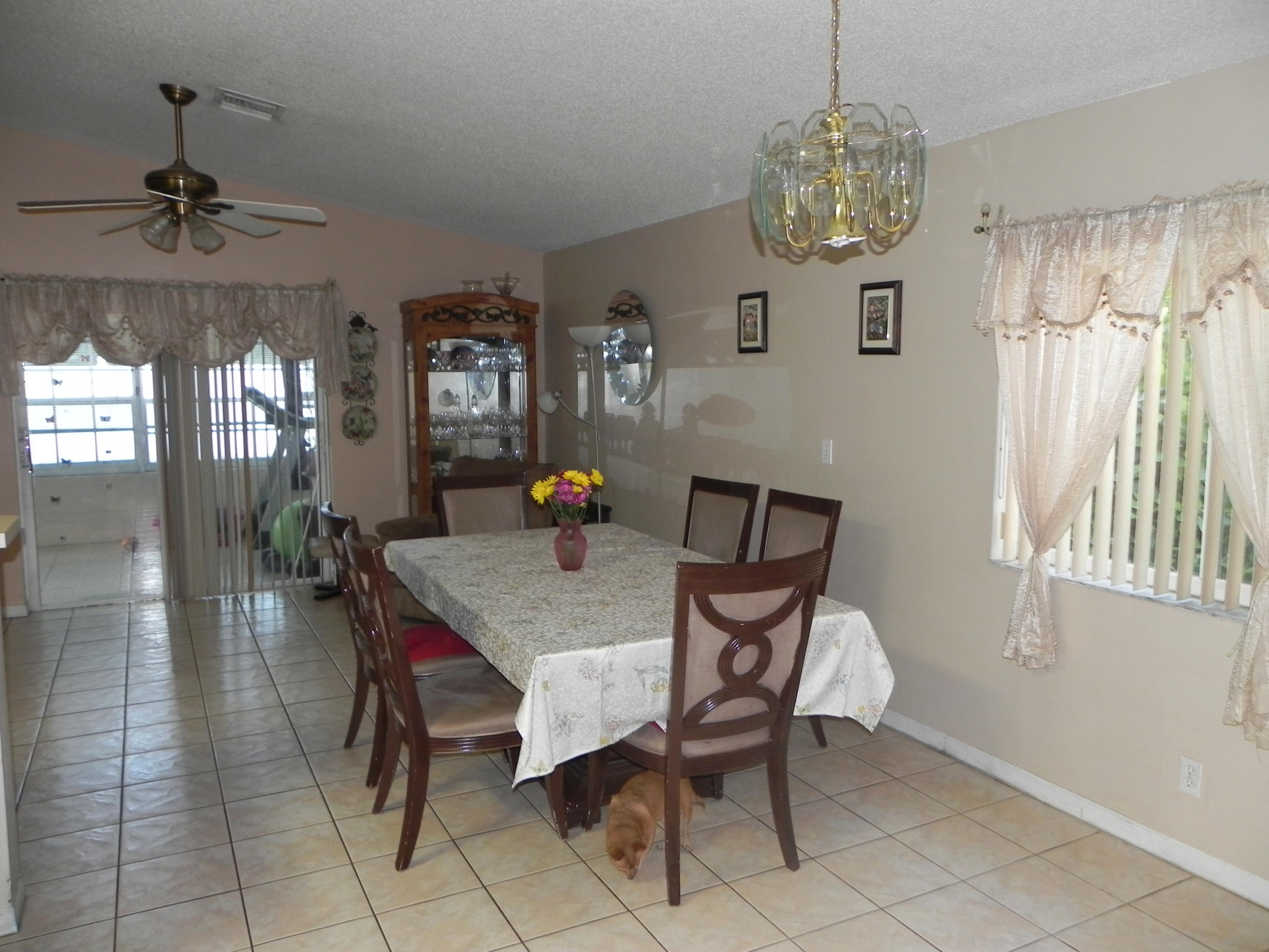 4629 Southwest 12th Street Deerfield Beach, FL 33442 - Photo 23 of 68 a view of a dining room with furniture and chandelier