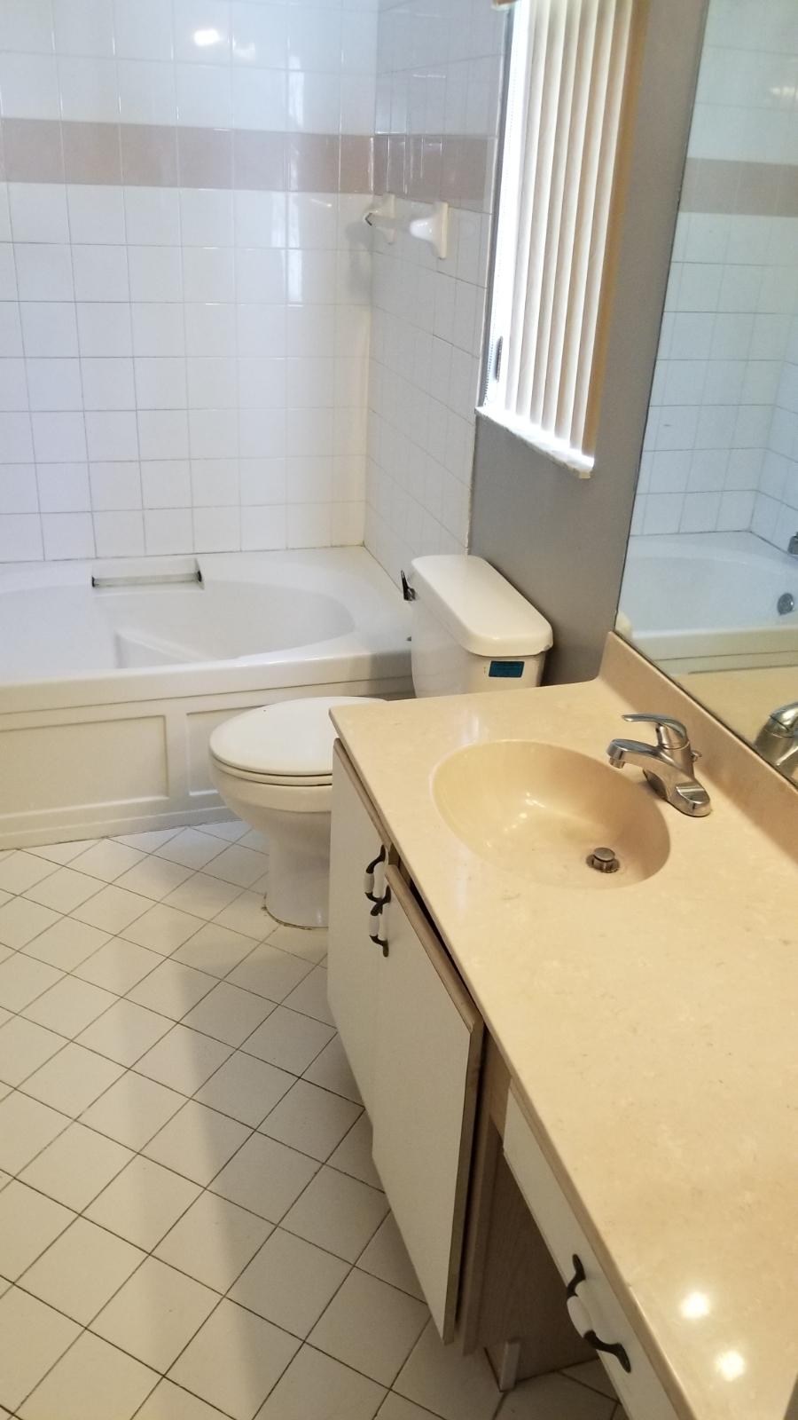 4629 Southwest 12th Street Deerfield Beach, FL 33442 - Photo 29 of 68 a bathroom with a sink vanity and a bathtub