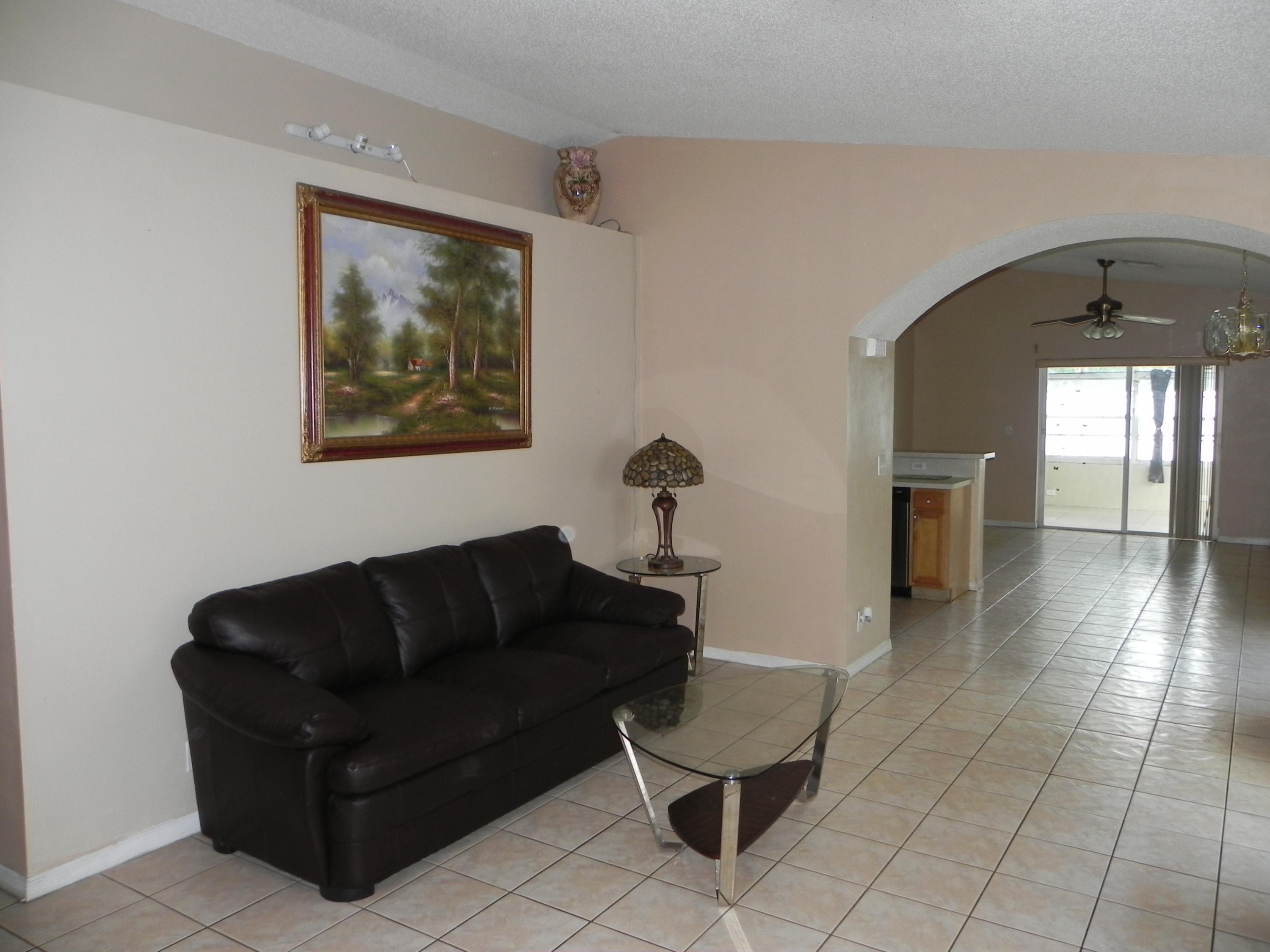 4629 Southwest 12th Street Deerfield Beach, FL 33442 - Photo 3 of 68 a living room with furniture and a fireplace