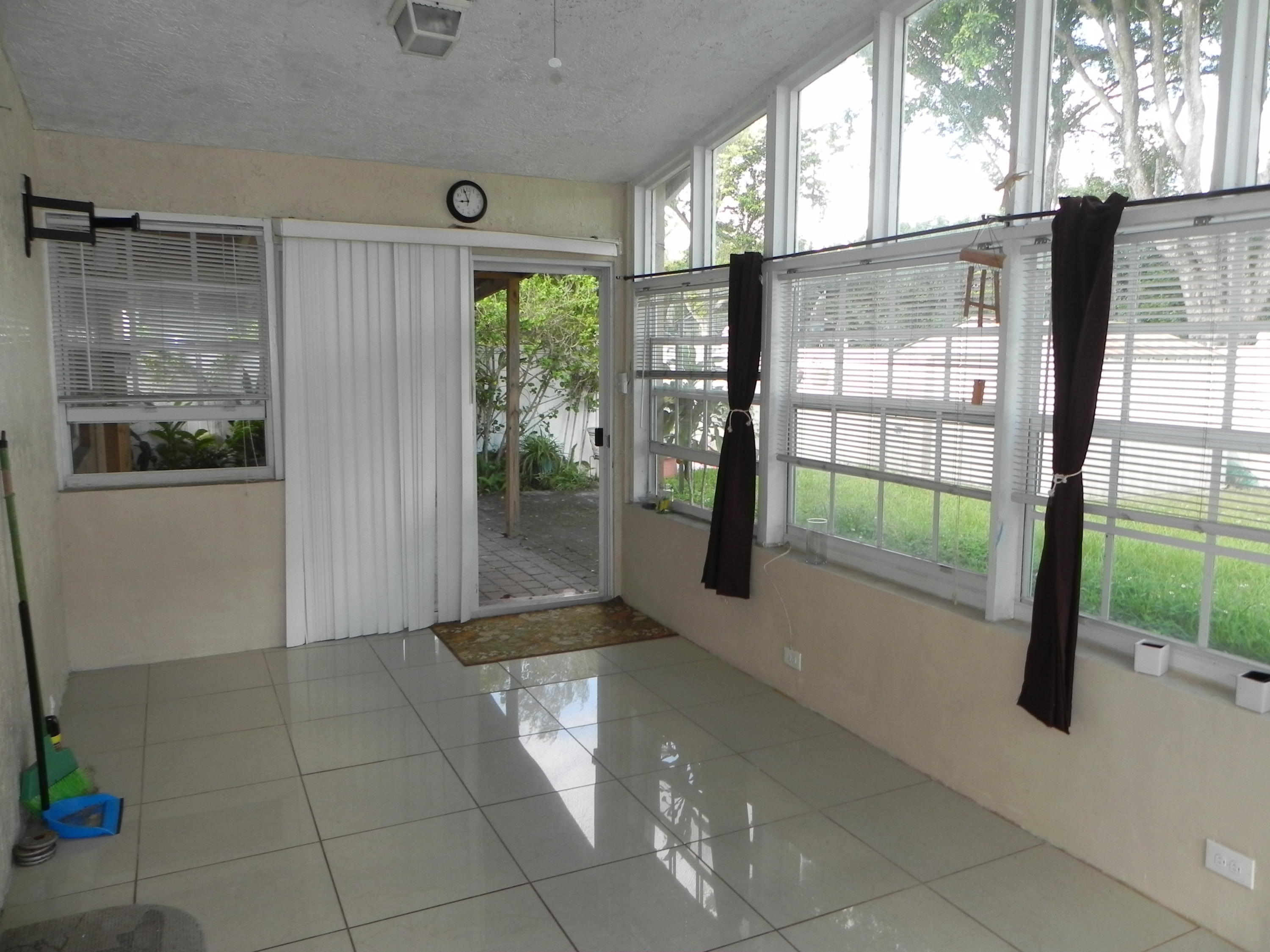4629 Southwest 12th Street Deerfield Beach, FL 33442 - Photo 40 of 68 a view of entryway with window and wooden floor