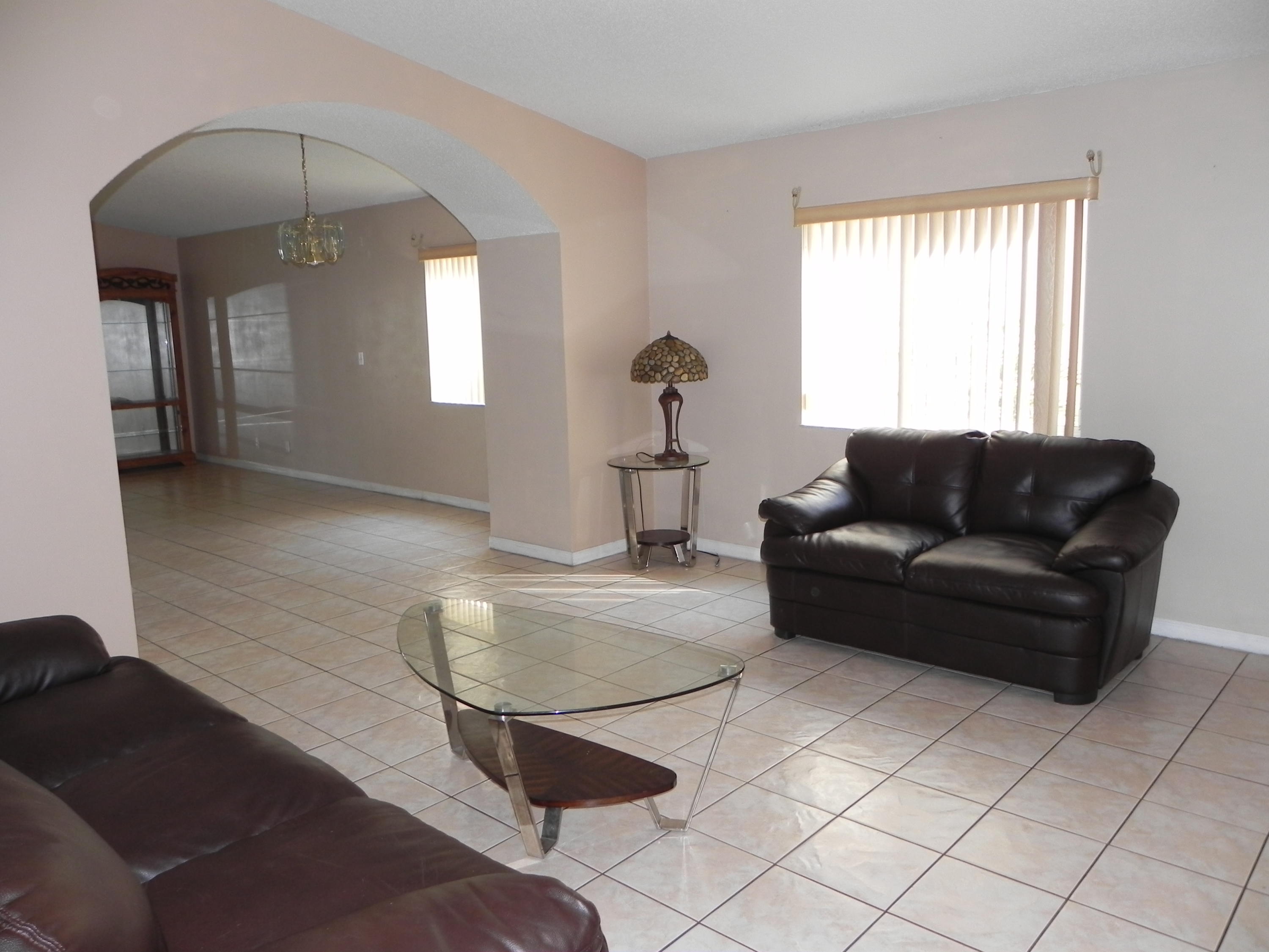 4629 Southwest 12th Street Deerfield Beach, FL 33442 - Photo 4 of 68 a living room with furniture and a window