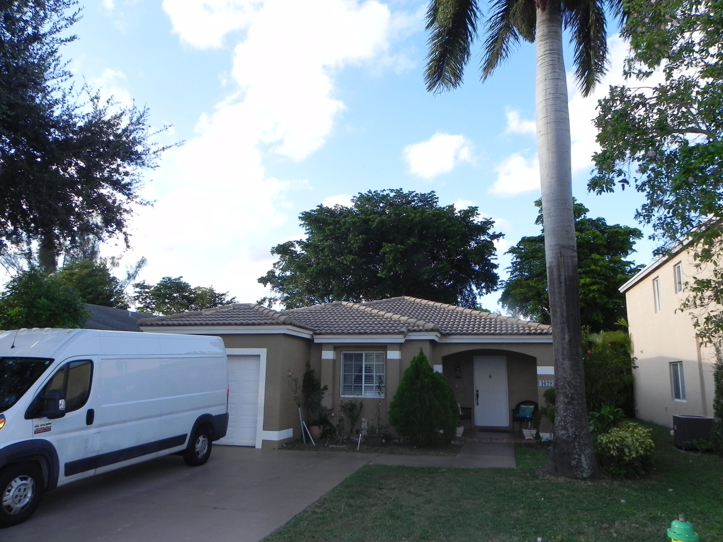 4629 Southwest 12th Street Deerfield Beach, FL 33442 - Photo 43 of 68 a view of a car park in front of a house