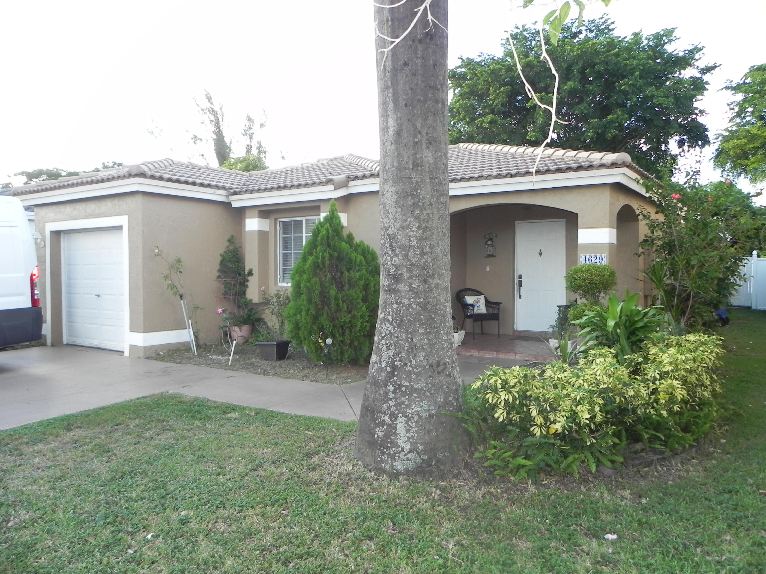4629 Southwest 12th Street Deerfield Beach, FL 33442 - Photo 45 of 68 a view of a house with porch and garden
