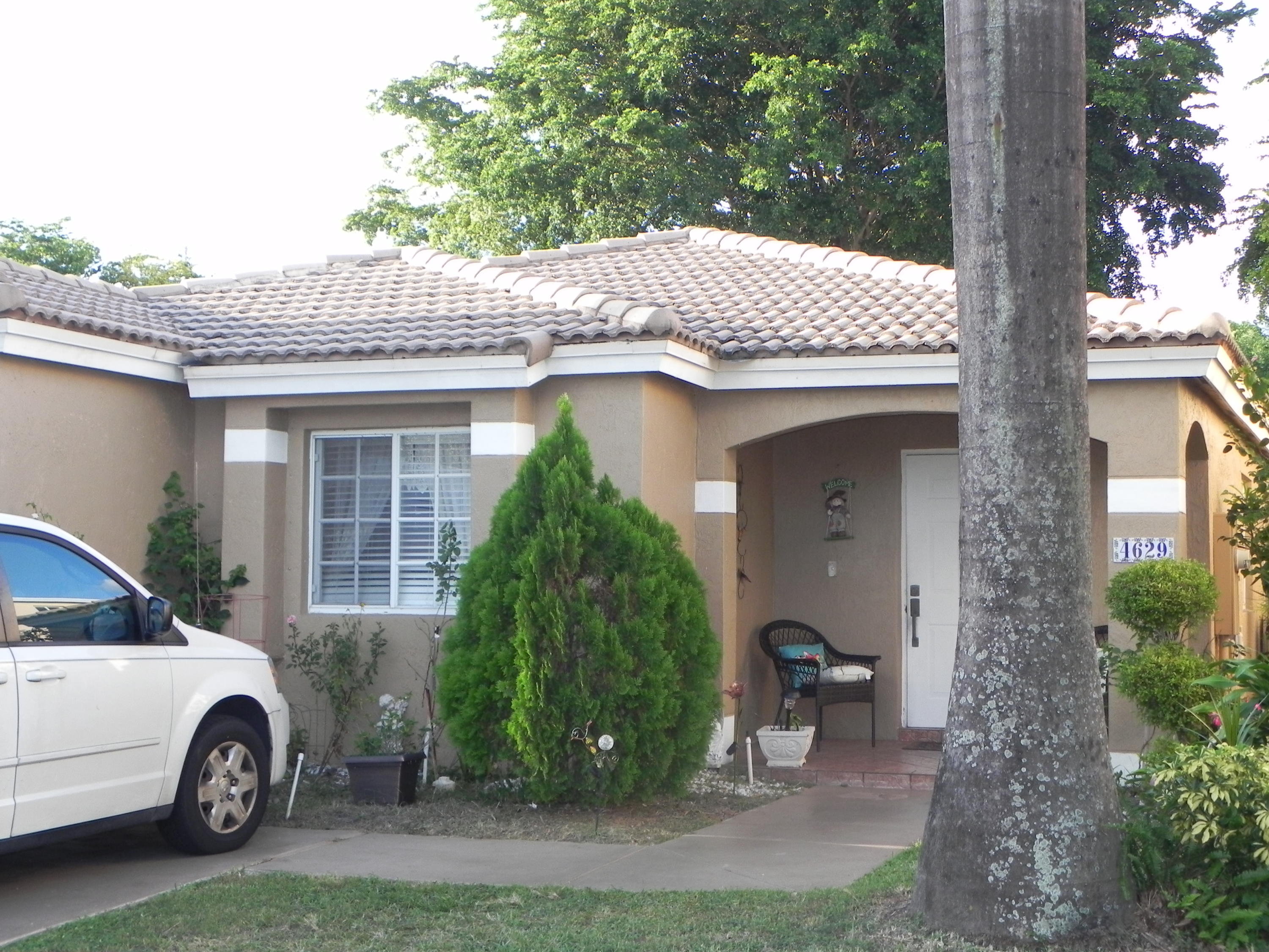 4629 Southwest 12th Street Deerfield Beach, FL 33442 - Photo 47 of 68 a front view of a house with a garden