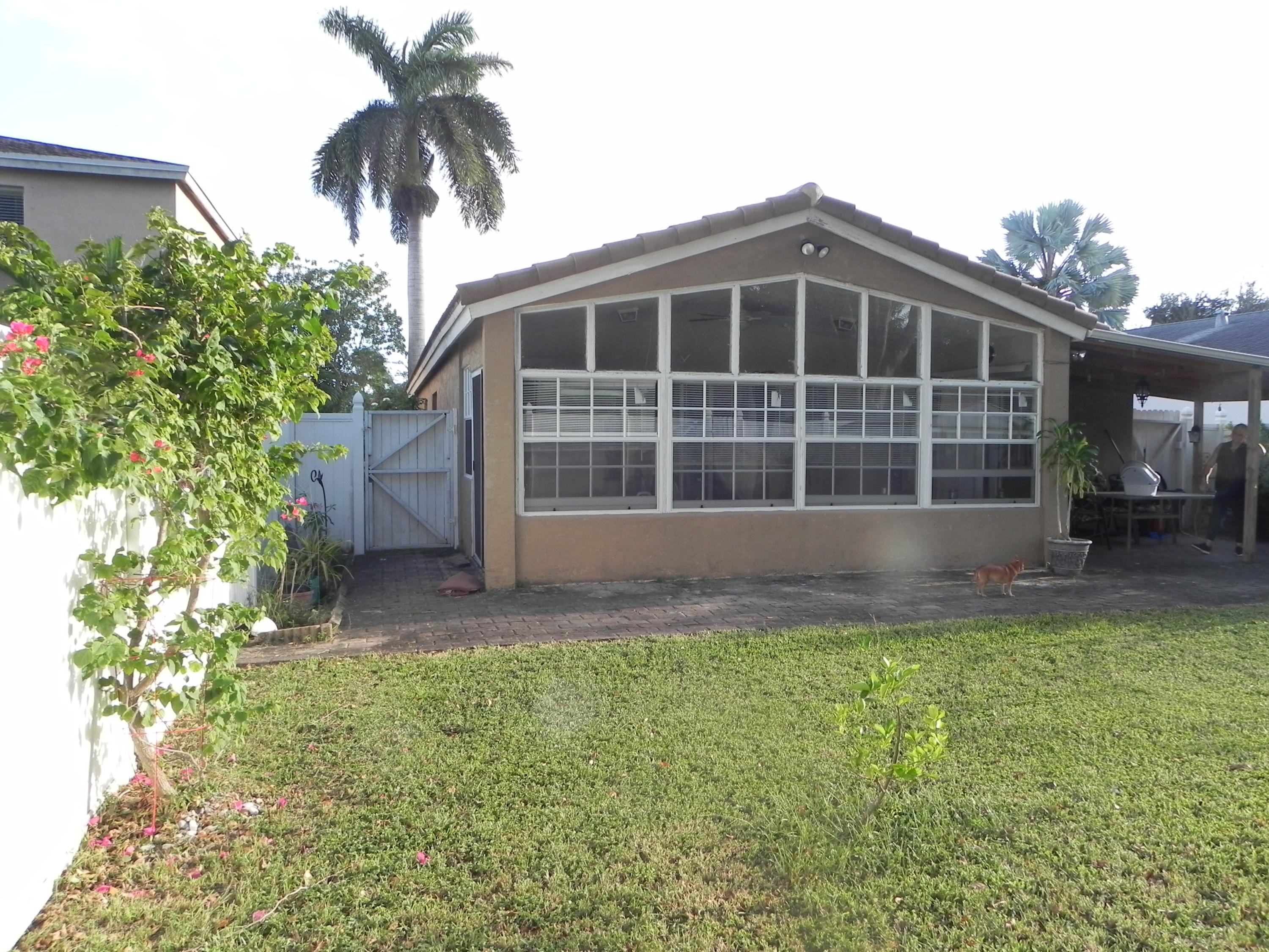 4629 Southwest 12th Street Deerfield Beach, FL 33442 - Photo 54 of 68 a front view of a house with a garden