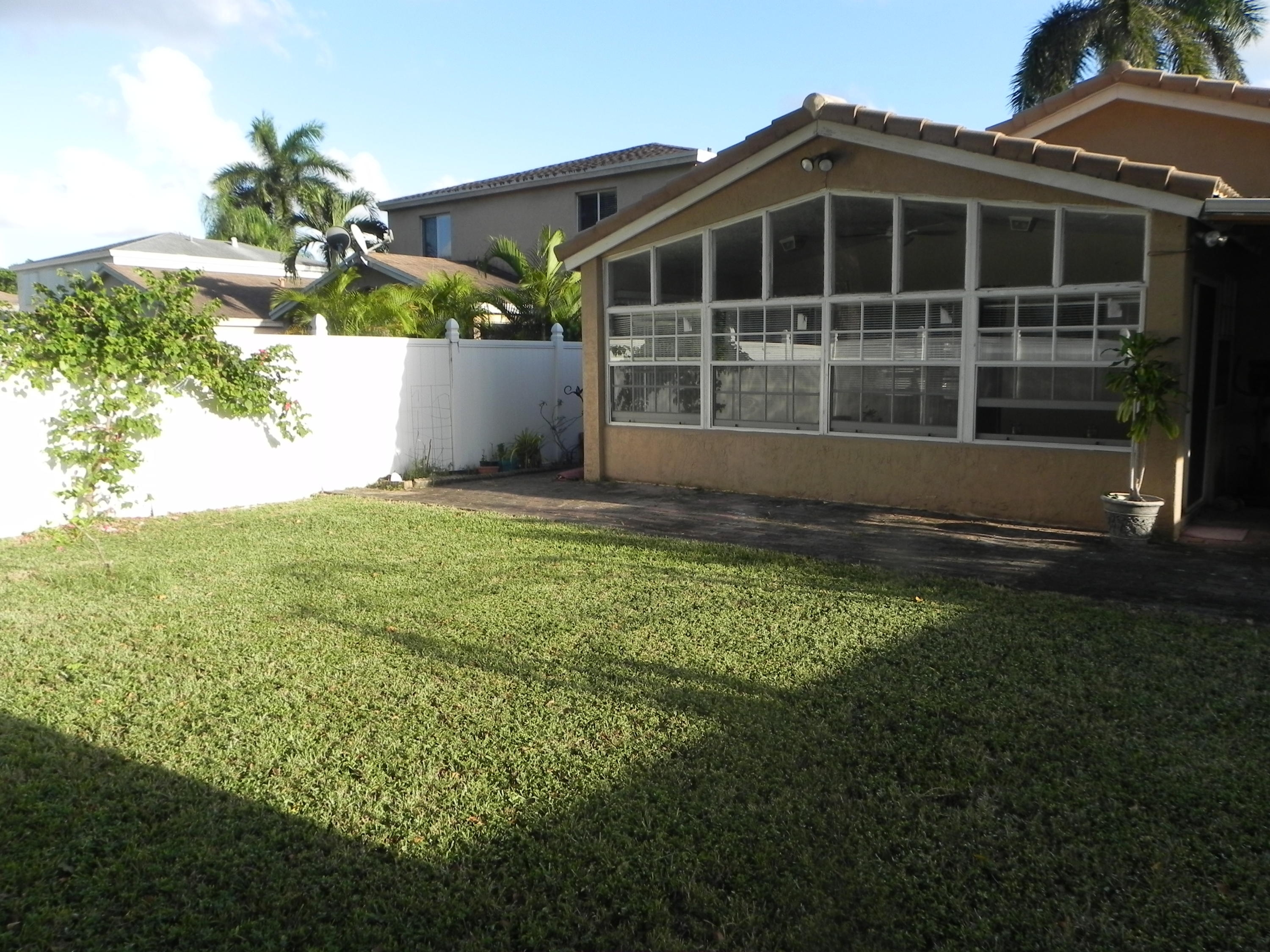4629 Southwest 12th Street Deerfield Beach, FL 33442 - Photo 55 of 68 a front view of a house with a yard and garage