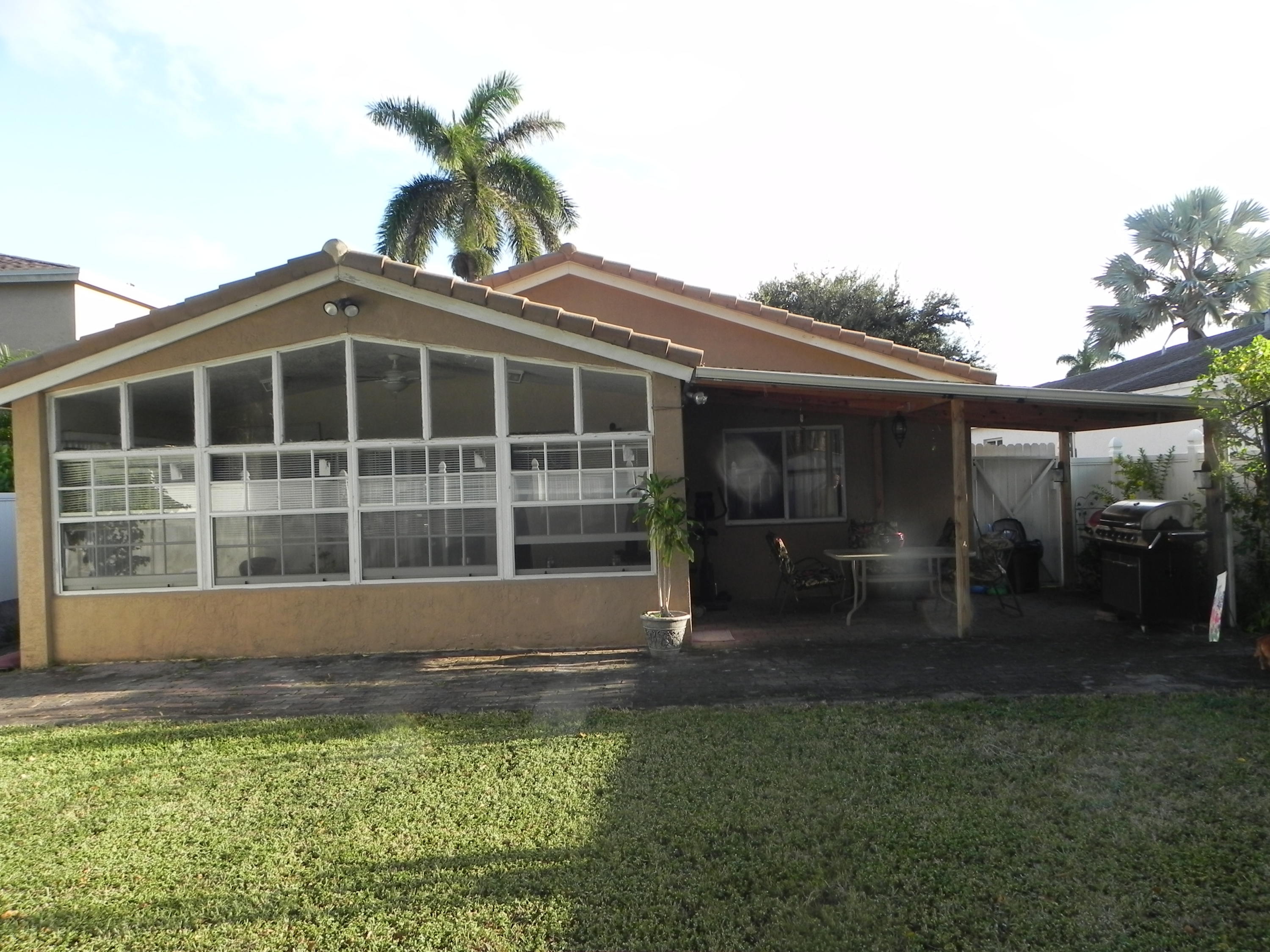 4629 Southwest 12th Street Deerfield Beach, FL 33442 - Photo 56 of 68 a front view of a house with a yard