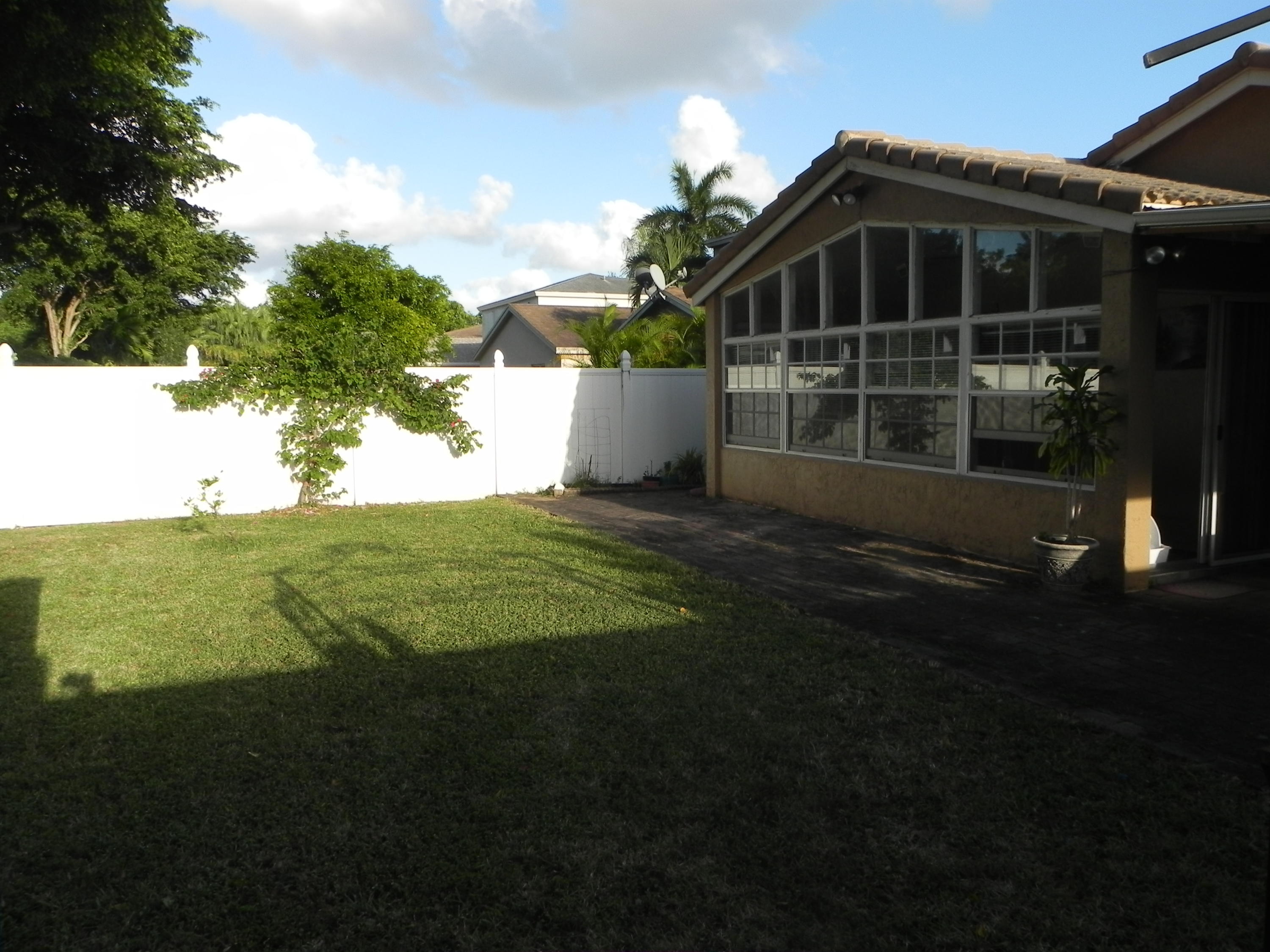 4629 Southwest 12th Street Deerfield Beach, FL 33442 - Photo 57 of 68 a front view of a house with a yard