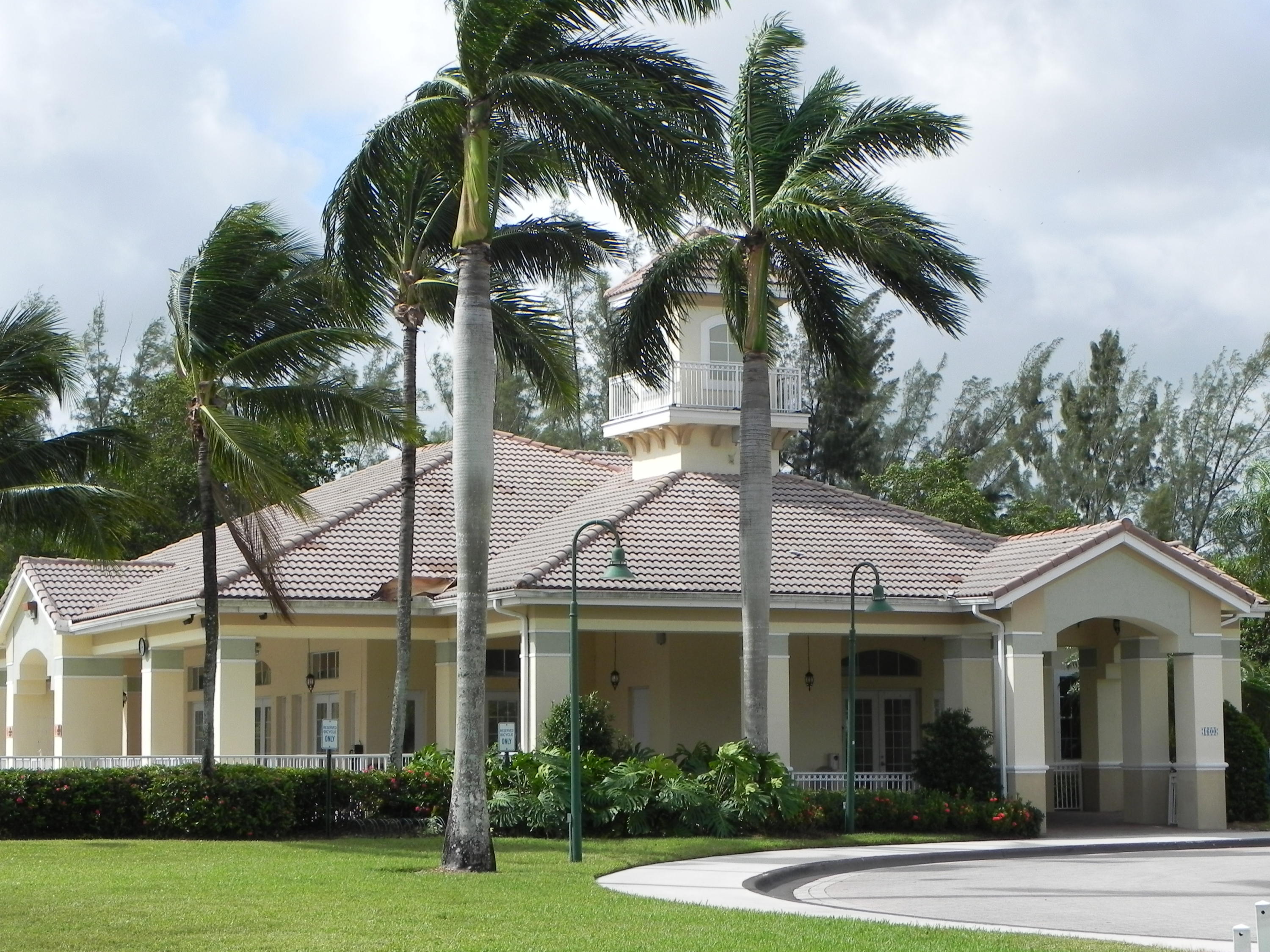 4629 Southwest 12th Street Deerfield Beach, FL 33442 - Photo 65 of 68 a view of a white house with a large windows and a yard with palm trees