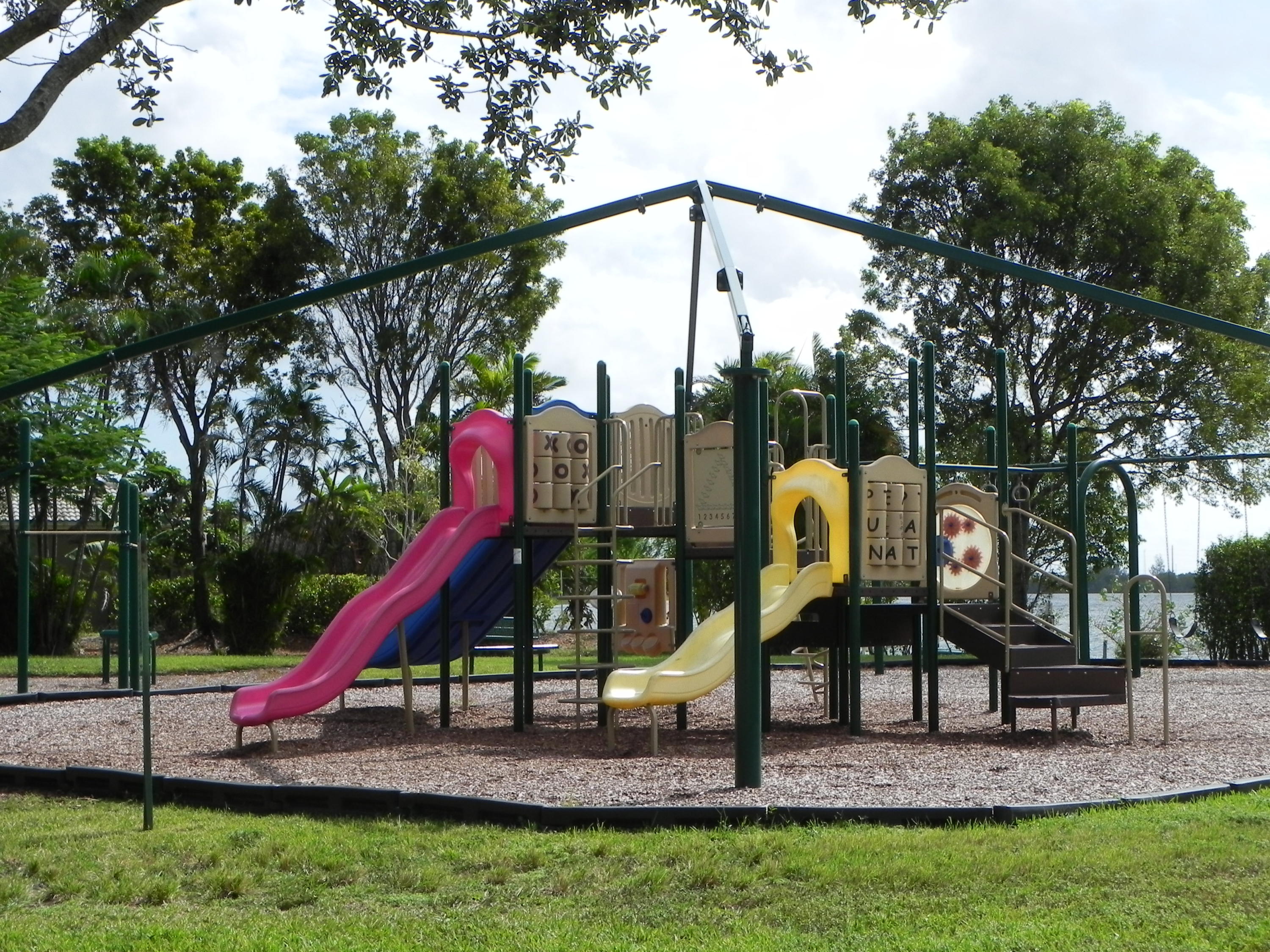 4629 Southwest 12th Street Deerfield Beach, FL 33442 - Photo 66 of 68 a childrens park with lots of swings and slides