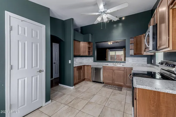 a kitchen with stainless steel appliances granite countertop a sink a stove and cabinets