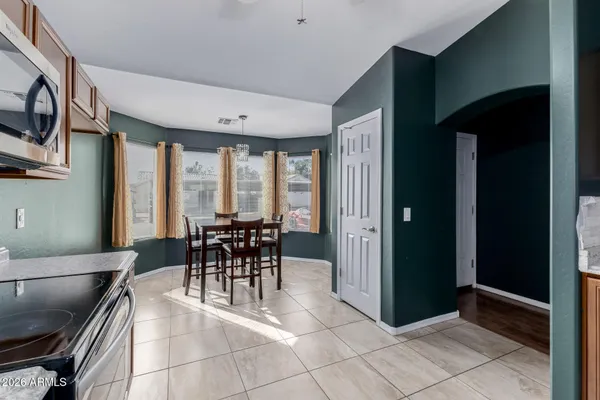 a dining room with furniture and a floor to ceiling window