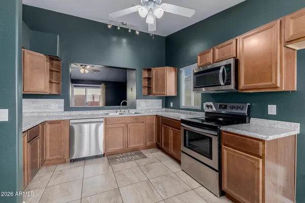 a kitchen with stainless steel appliances granite countertop a sink and a stove top oven