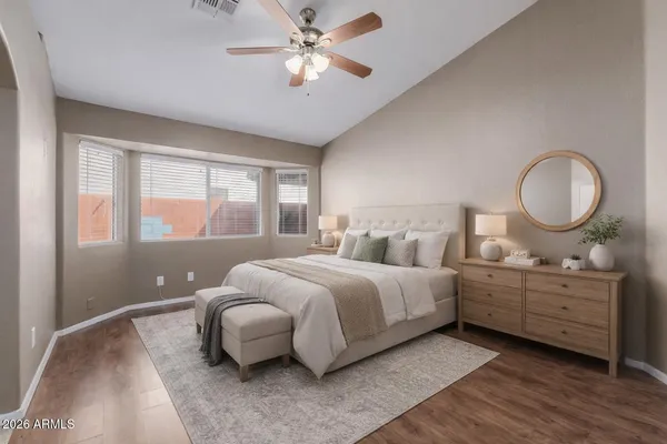 a bedroom with bed and a large window