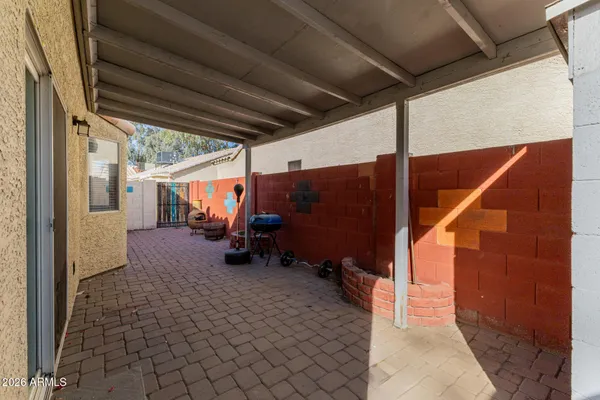 a view of a porch with furniture and a yard