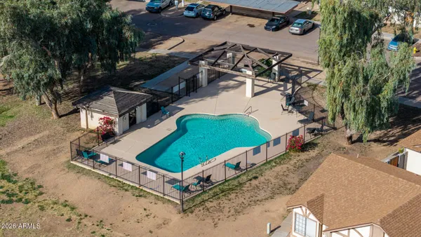 an aerial view of a house with backyard