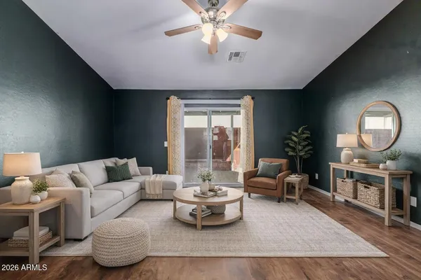 a living room with furniture chandelier and a large window