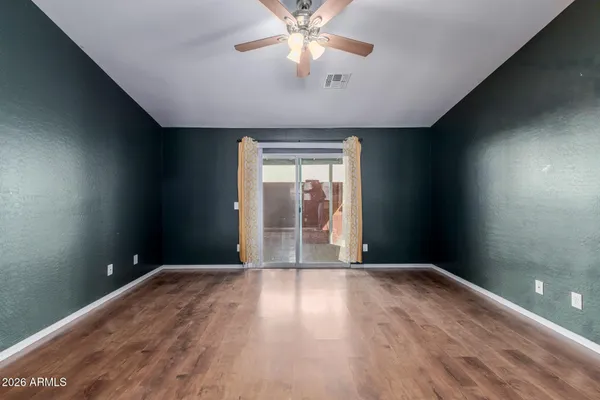 wooden floor in an empty room with a window