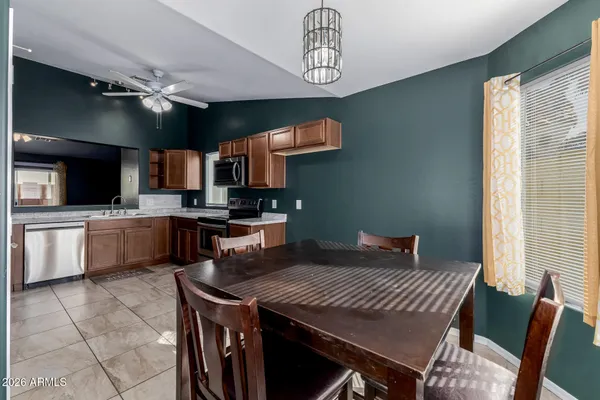 a kitchen with a table chairs microwave and cabinets