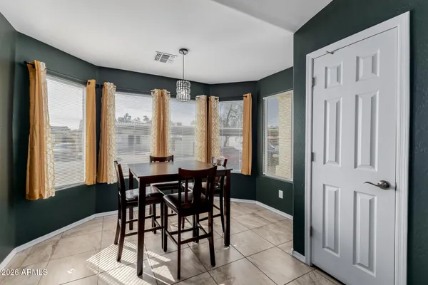 a view of a a dining room with furniture window and outside view