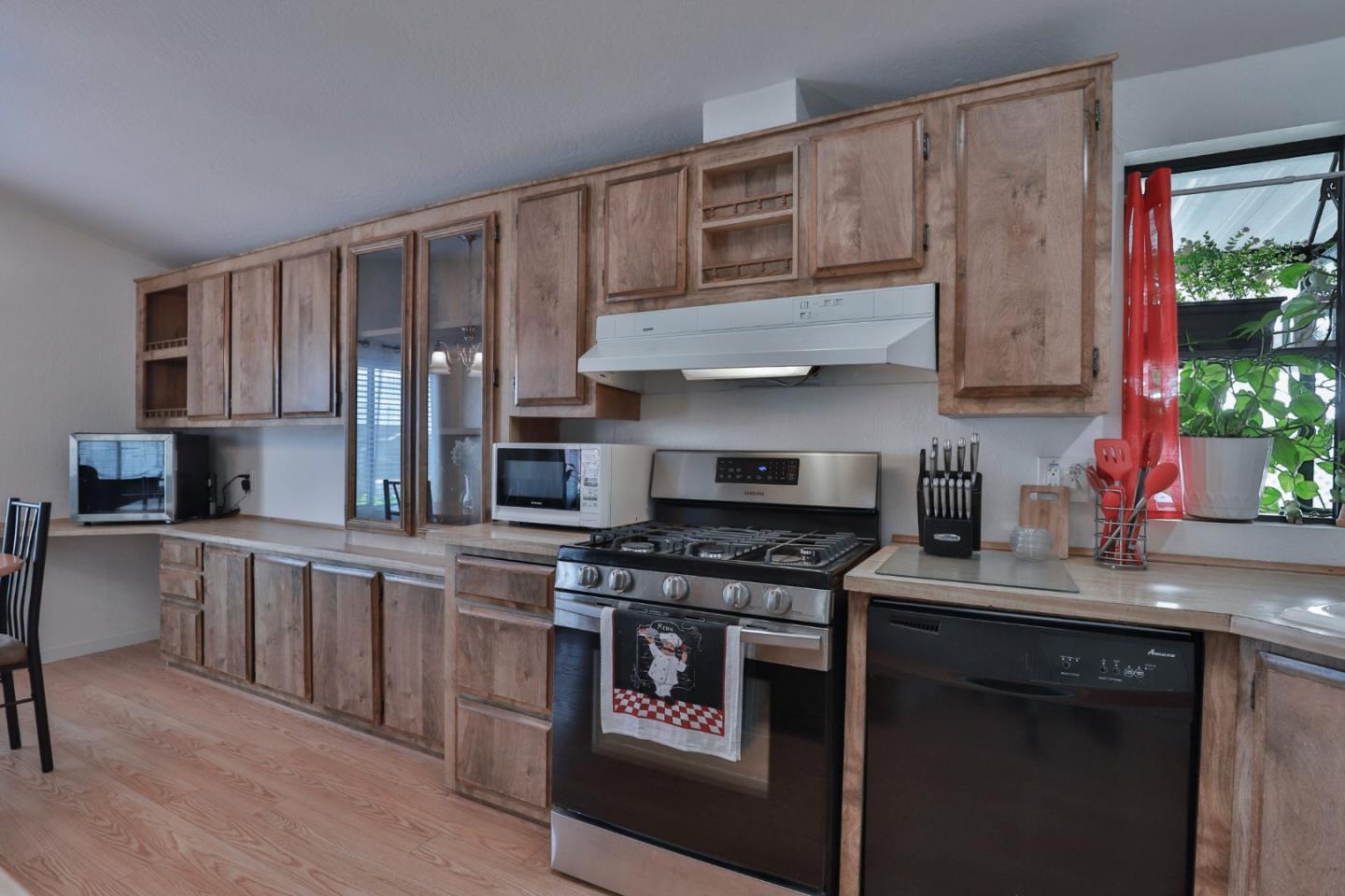 11662 North Ham Lane, Unit 62 Lodi, CA 95242 - Photo 12 of 25 a kitchen with stainless steel appliances granite countertop a stove sink and cabinets