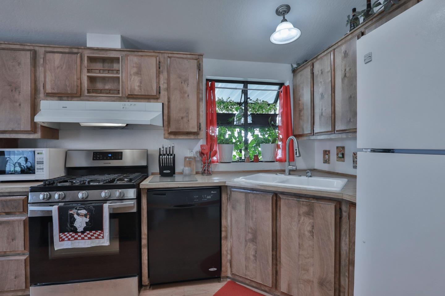 11662 North Ham Lane, Unit 62 Lodi, CA 95242 - Photo 13 of 25 a kitchen with stainless steel appliances granite countertop a stove a sink and a microwave