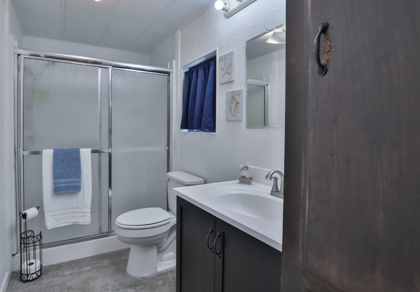 11662 North Ham Lane, Unit 62 Lodi, CA 95242 - Photo 16 of 25 a bathroom with a sink toilet and shower
