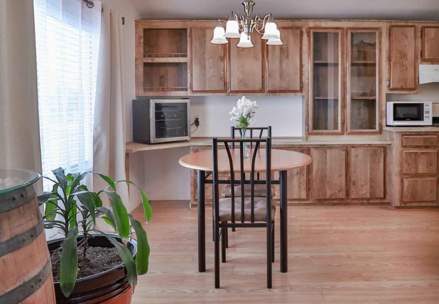 11662 North Ham Lane, Unit 62 Lodi, CA 95242 - Photo 8 of 25 a view of a dining room with furniture window and wooden floor
