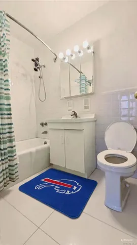 a bathroom with a sink a bath tub and a toilet