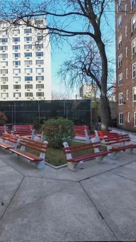 a backyard of a house with barbeque oven table and chairs