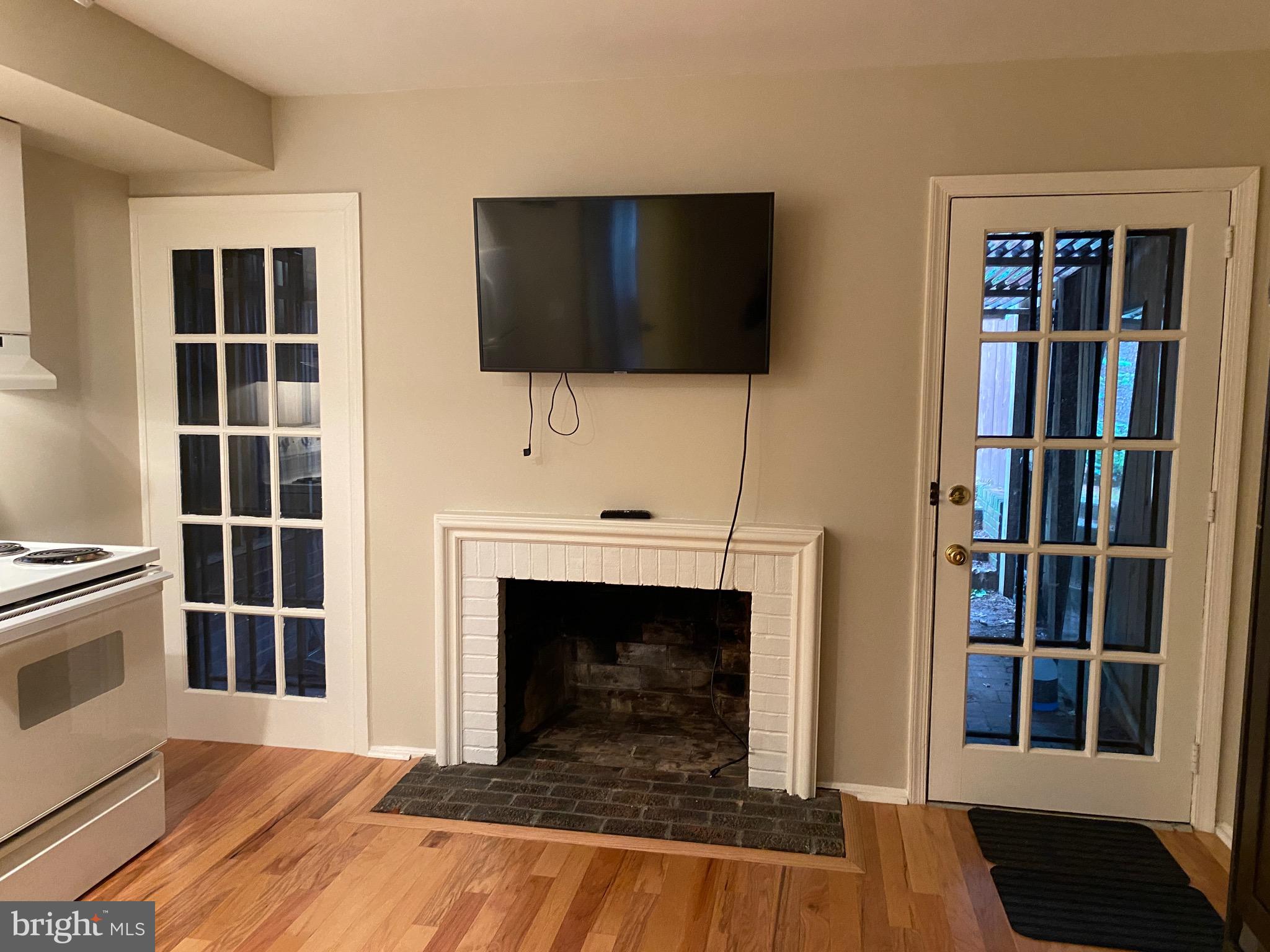 339 11th Street Southeast Washington, DC 20003 - Photo 8 of 39 a living room with a fireplace and a flat screen tv