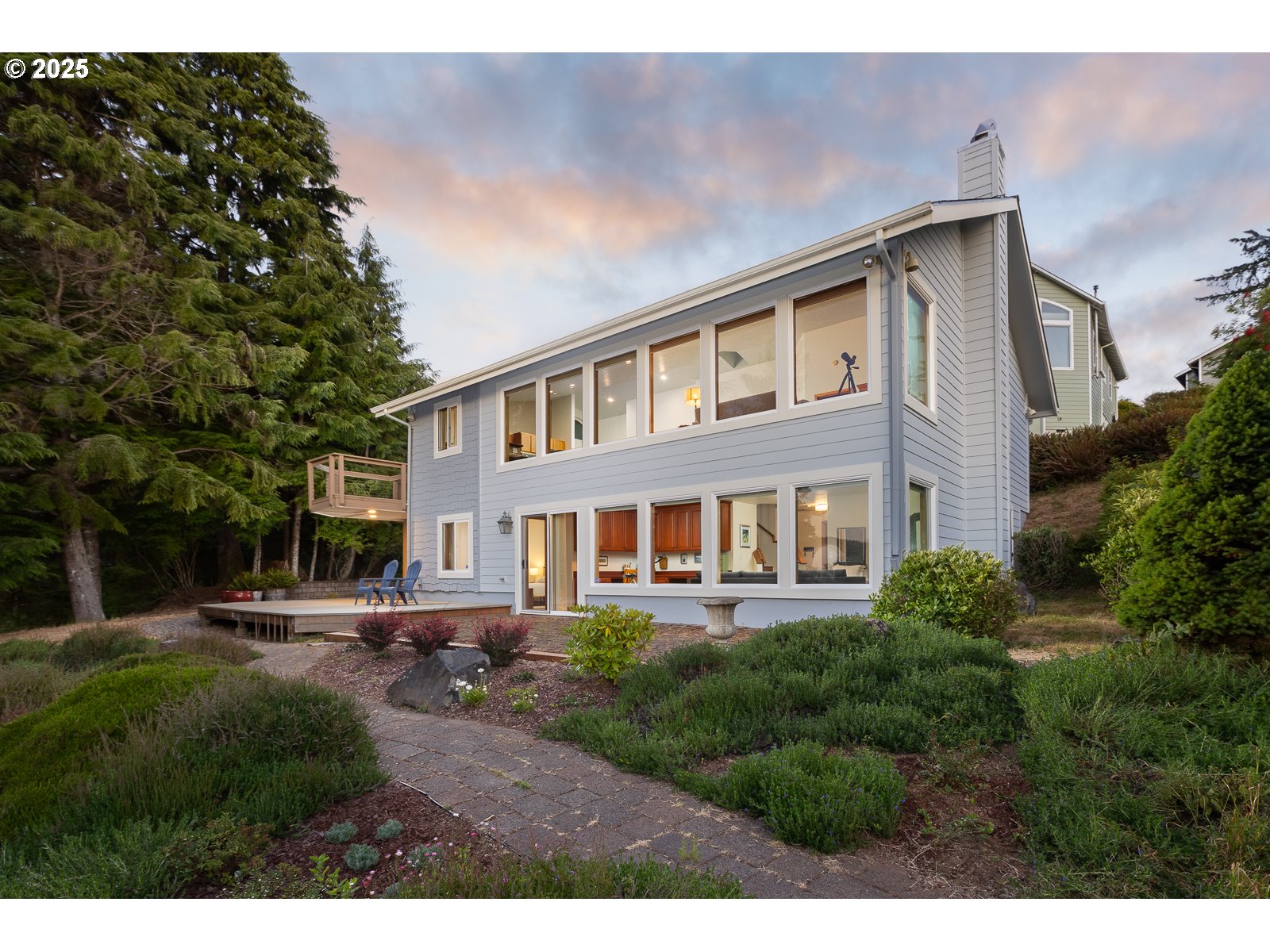a front view of a house with a yard and lake view