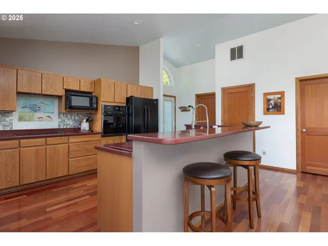 a kitchen with stainless steel appliances granite countertop a refrigerator and a stove top oven