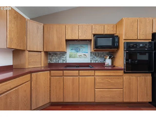 a kitchen with stainless steel appliances granite countertop a refrigerator sink and cabinets