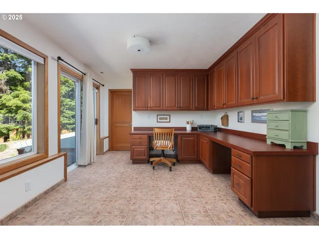 a kitchen with a refrigerator and a stove top oven