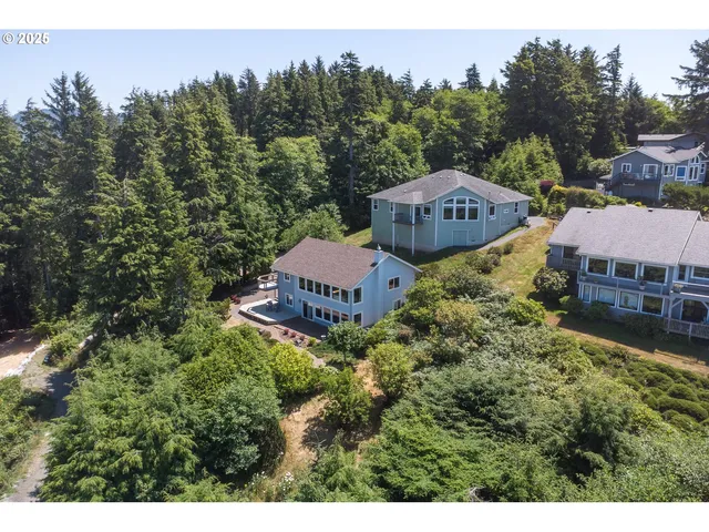 a view of a house with a yard and trees