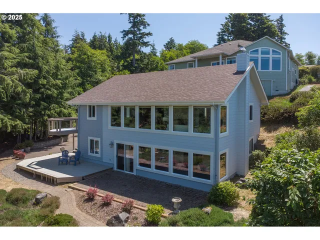 a aerial view of a house next to a yard