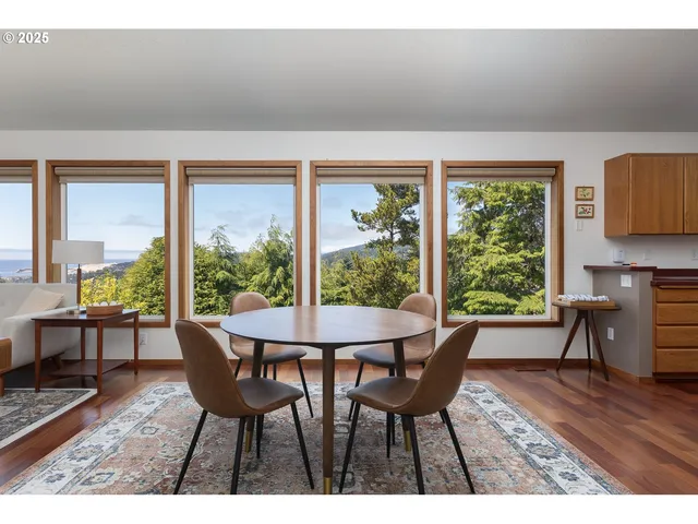 a dining room with furniture and wooden floor