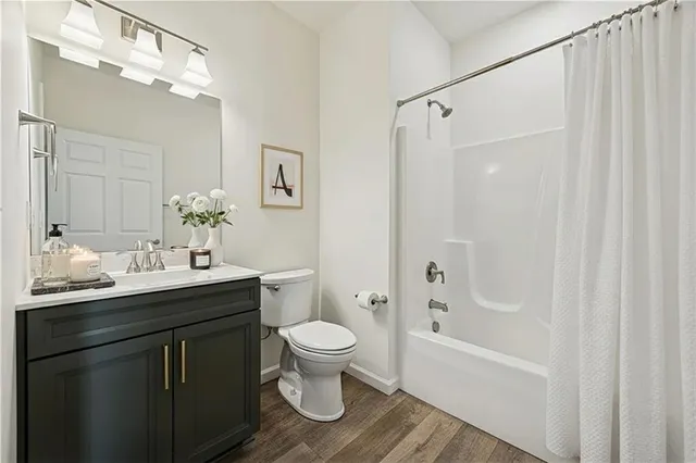 a living room with furniture a table tennis table and a potted plant
