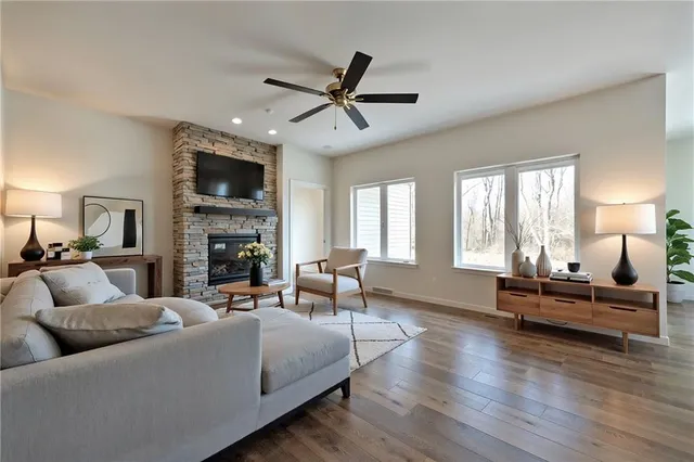a living room with furniture fireplace and a window