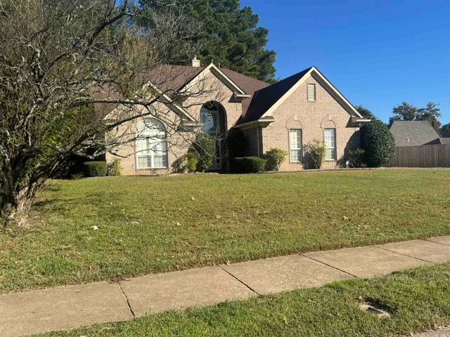 a front view of a house with yard