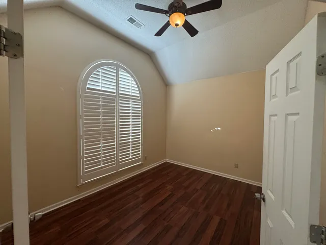 a view of a room with wooden floor and window