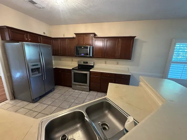 a kitchen with a sink a stove and refrigerator