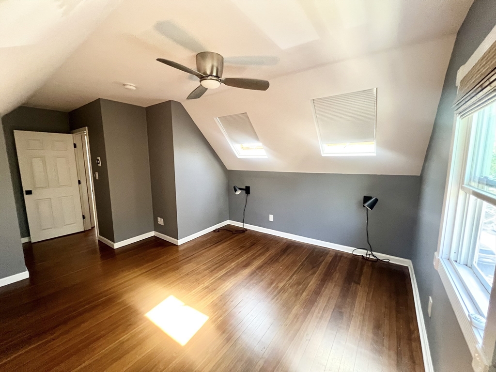 52 Victoria Street, Unit B Somerville, MA 02144 - Photo 14 of 15 a view of an empty room with a window and wooden floor