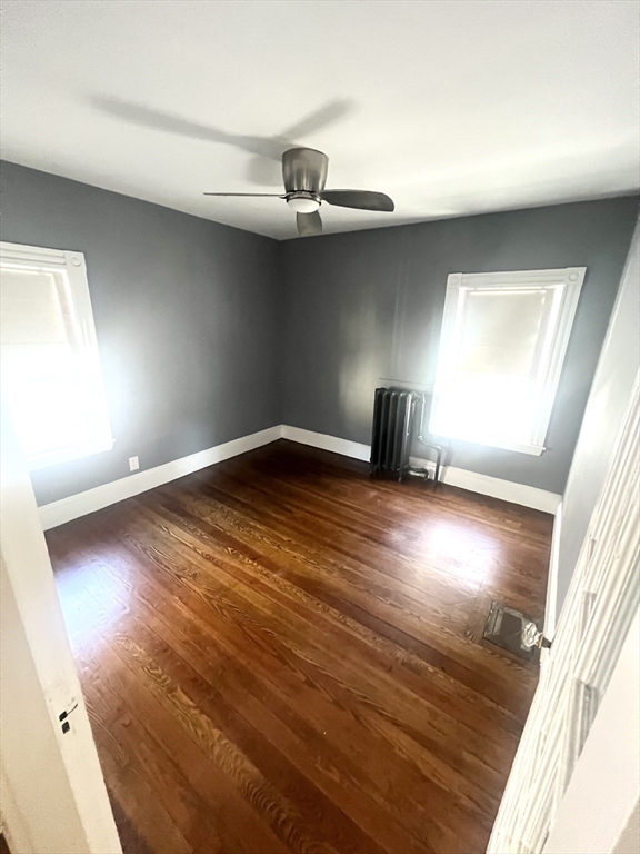 52 Victoria Street, Unit B Somerville, MA 02144 - Photo 15 of 15 an empty room with wooden floor and windows