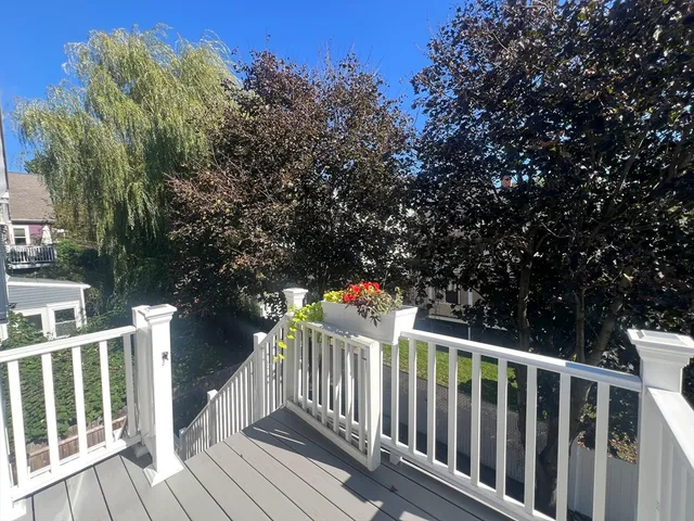 a balcony with wooden floor and fence