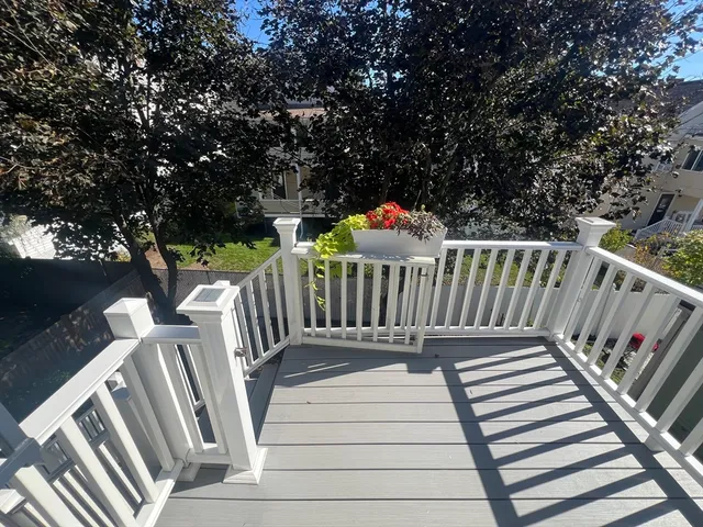 a view of deck with white and wooden fence