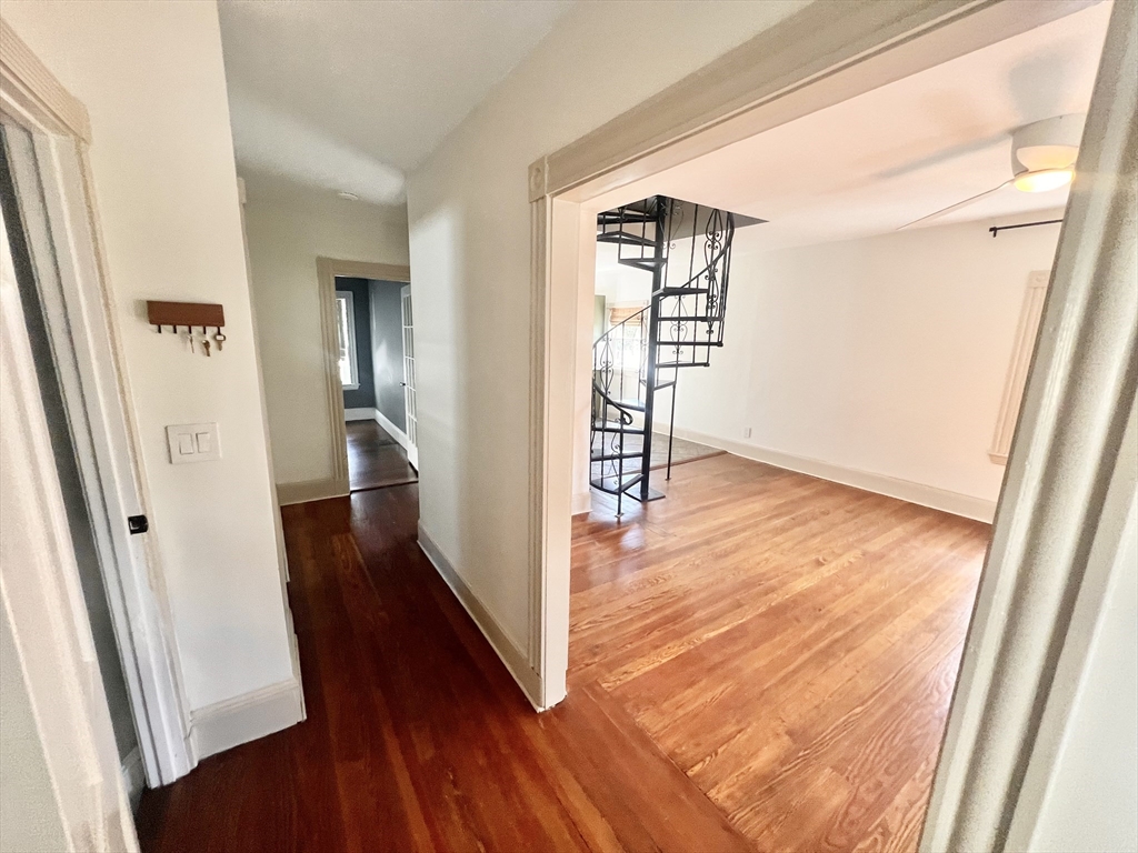 52 Victoria Street, Unit B Somerville, MA 02144 - Photo 6 of 15 a view of a hallway with wooden floor and staircase