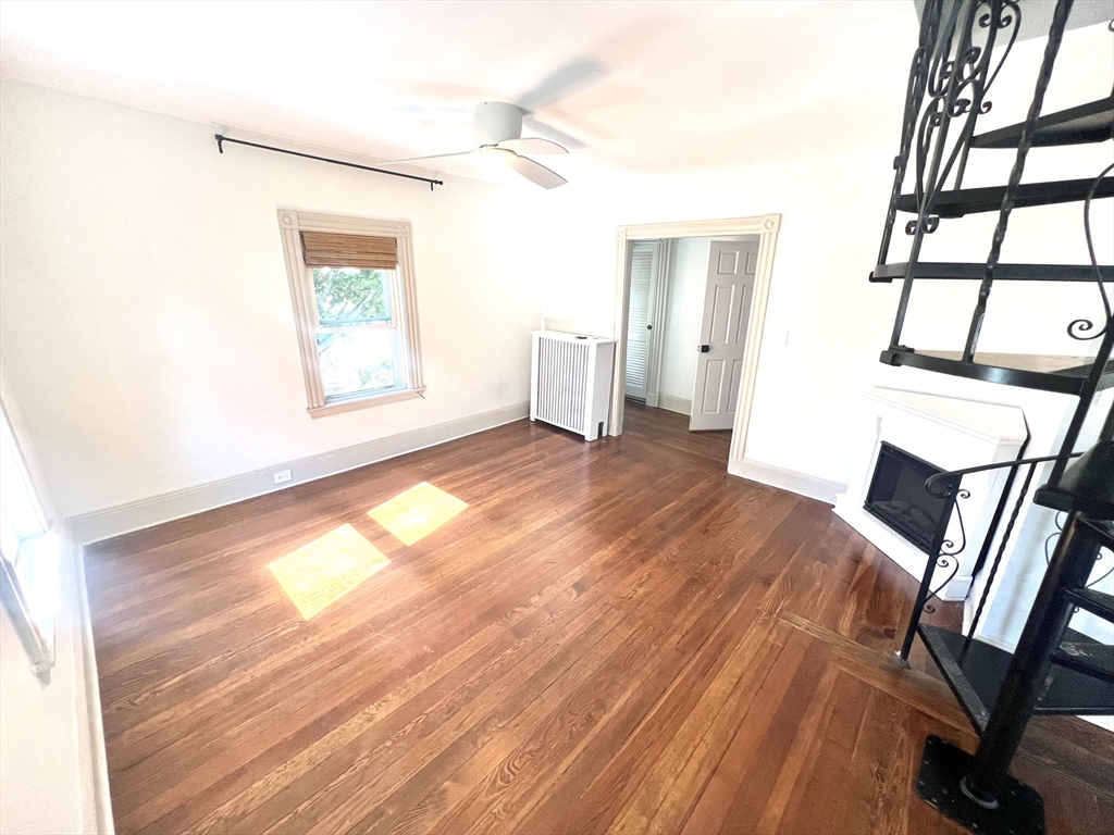 52 Victoria Street, Unit B Somerville, MA 02144 - Photo 7 of 15 a view of an empty room with wooden floor and a window