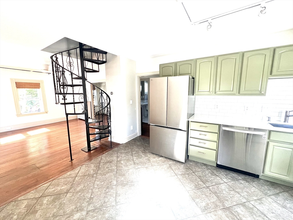 52 Victoria Street, Unit B Somerville, MA 02144 - Photo 8 of 15 a kitchen with granite countertop a refrigerator and a stove top oven